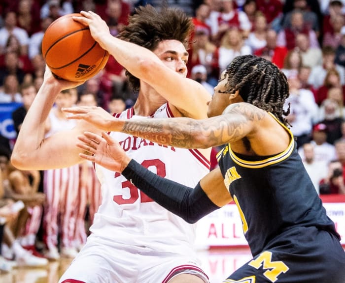Trey Galloway (32) looks to pass around Michigan's Dug McDaniel (0) during the first half of Indiana versus Michigan.